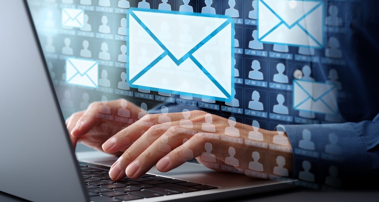 Email marketing automation technology and customer database. Businessman typing on laptop computer keyboard at desk in office.